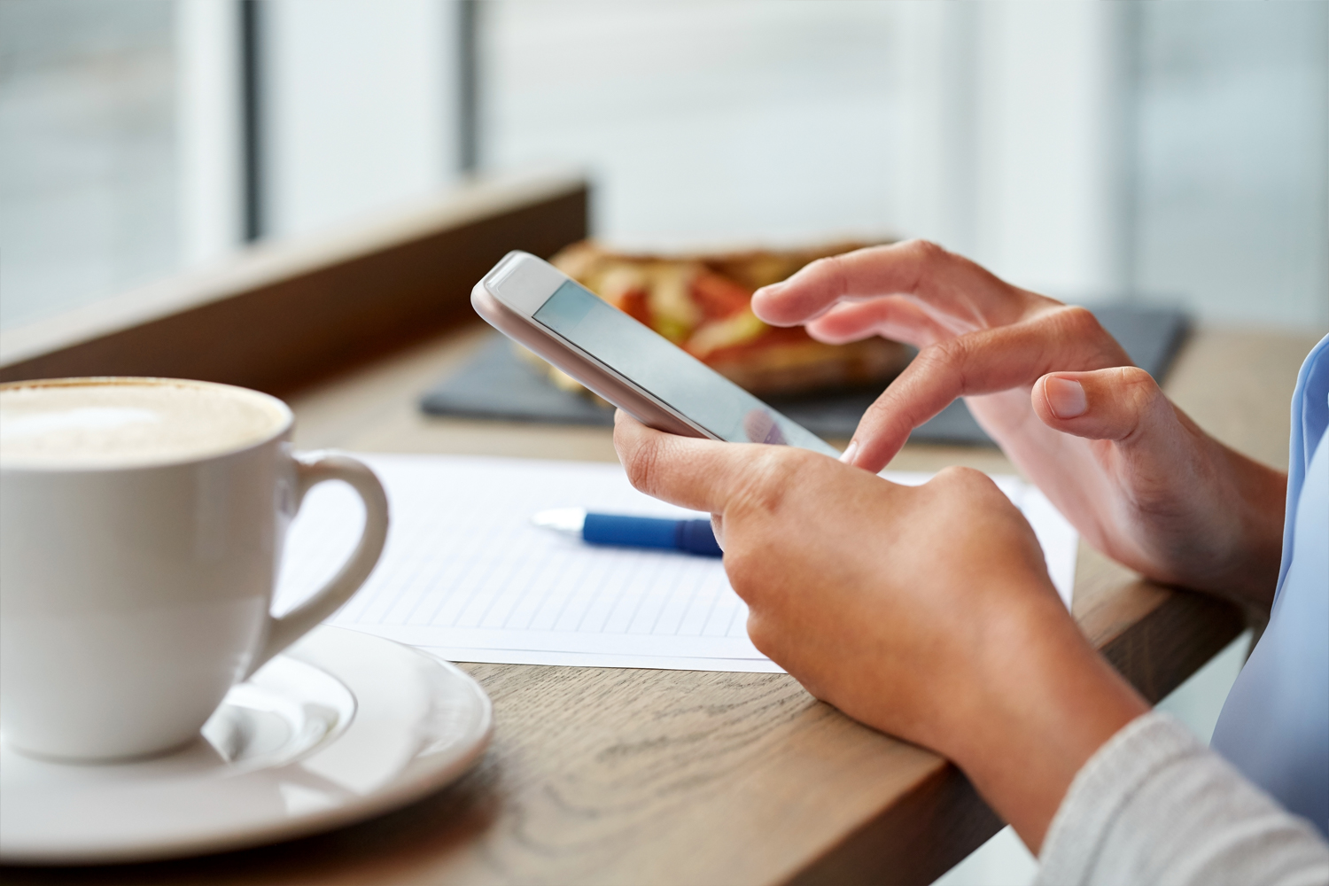 Customer using safe public WiFi in a cafe under the Government's friendly WiFi scheme