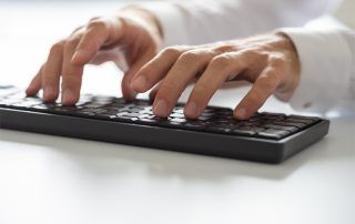Employee at a business using keyboard shortcuts for increased efficiency